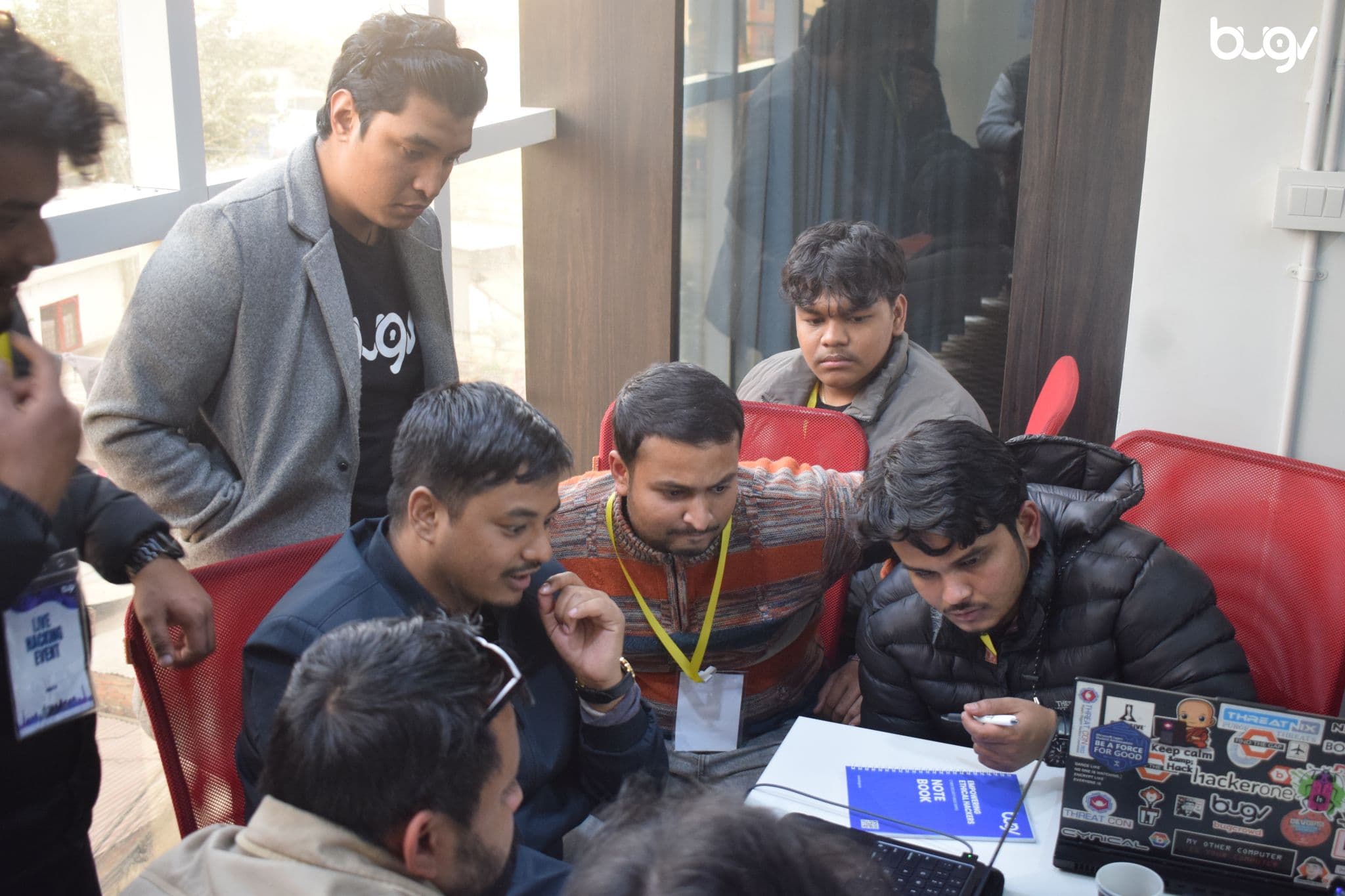 Bugv team collaborating around a laptop